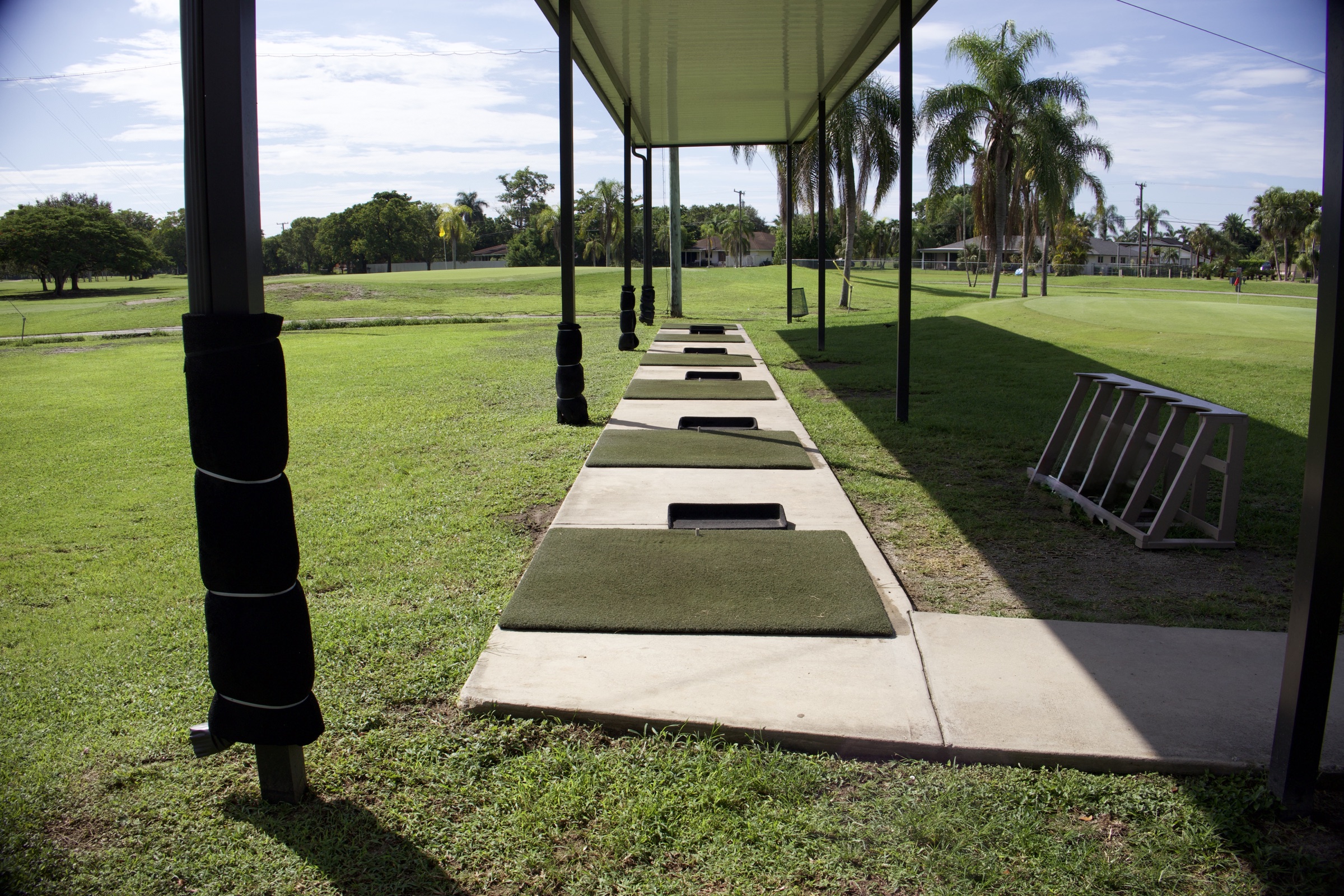 Covered practice bays looking out across the Redland Golf driving range.